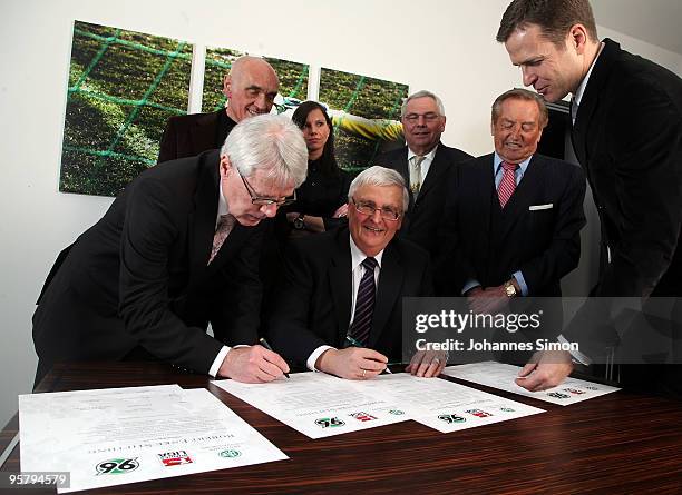 Officials Reinhard Rauball and Theo Zwanziger sign the charter of the Robert Enke Foundation in presence of Martin Kind, Teresa Enke, widow of...