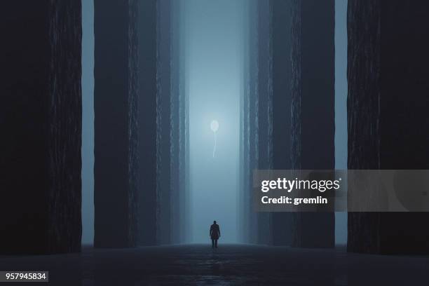 lost man walking in dark foggy street towards illuminated balloon - horror scene stock pictures, royalty-free photos & images