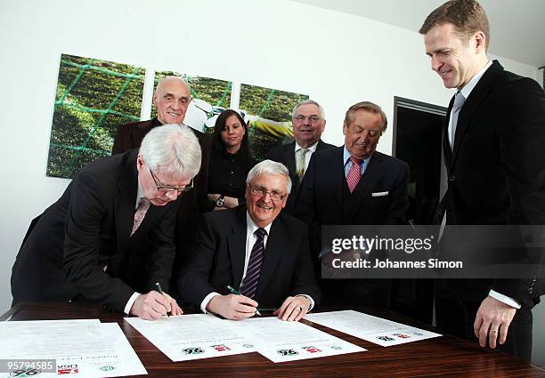 Officials Reinhard Rauball and Theo Zwanziger sign the charter of the Robert Enke Foundation in presence of Martin Kind, Teresa Enke, widow of...