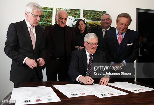 Officials Reinhard Rauball and Theo Zwanziger sign the charter of the Robert Enke Foundation in presence of Martin Kind, Teresa Enke, widow of...