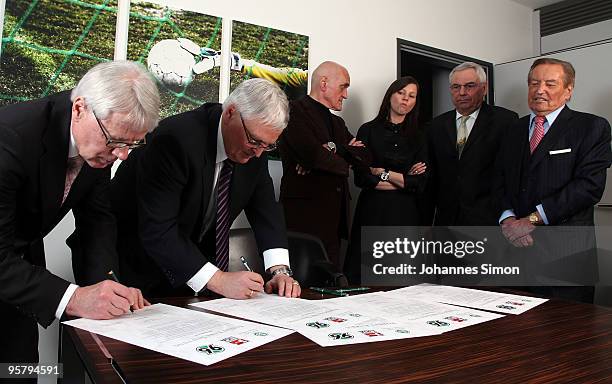 Officials Reinhard Rauball and Theo Zwanziger sign the charter of the Robert Enke Foundation in presence of Martin Kind, Teresa Enke, widow of...