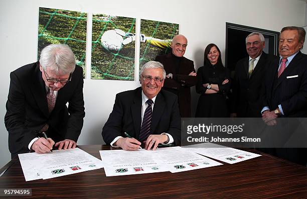 Officials Reinhard Rauball and Theo Zwanziger sign the charter of the Robert Enke Foundation in presence of Martin Kind, Teresa Enke, widow of...