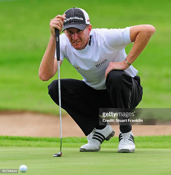 David Lynn of England lines up his putt on the 14th hole during the second round of the Joburg Open at Royal Johannesburg and Kensington Golf Club on...