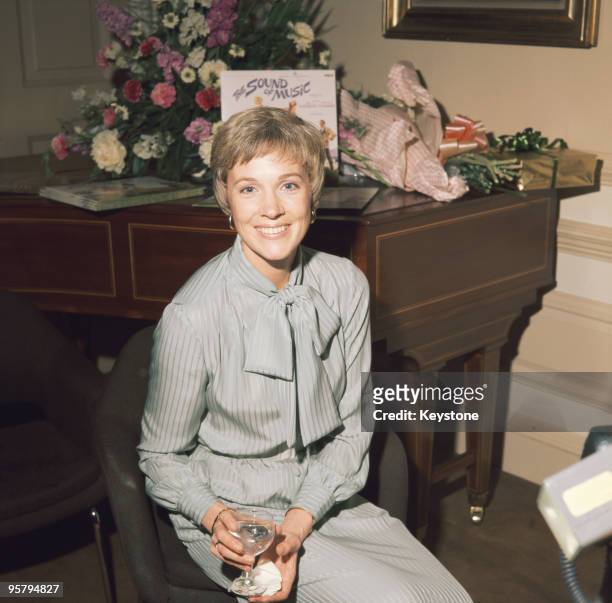 British actress and singer Julie Andrews, circa 1965. Behind her is the soundtrack to her recent film 'The Sound of Music'.