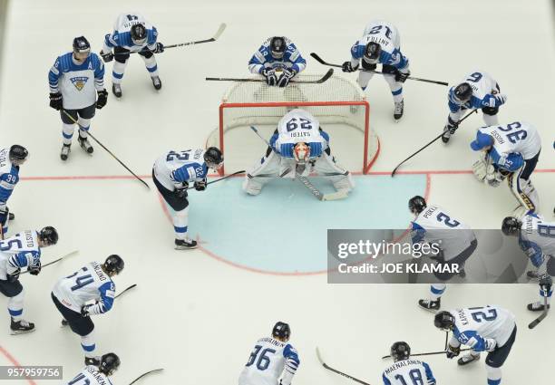 Players of Finland take a moment around Finland's goalkeeper Harri Sateri during the group B match Canada vs Finland of the 2018 IIHF Ice Hockey...