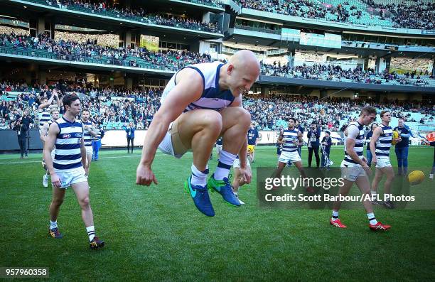 Gary Ablett of the Cats jumps in the air as they run through their banner and onto the field during the round eight AFL match between the Collingwood...