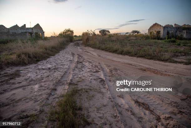 Unfinished houses are seen near the airport in Kolwezi on May 7, 2018. - The airport was the site of the battles for Kolwezi, in May 1978 during the...