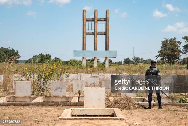 Congolese policeman stands near the Unknown Soldier monument in Kolwezi on April 24, 2018. - The monument was erected by the late Congolese President...
