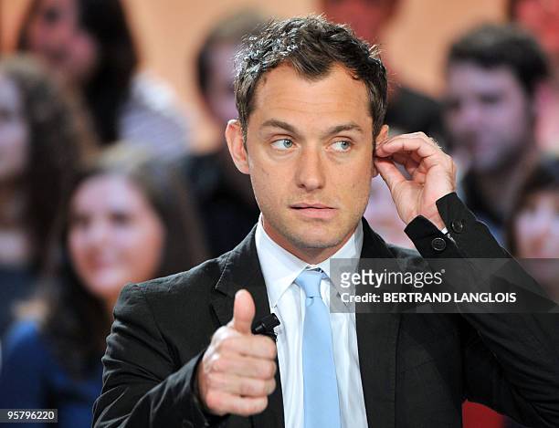 British Jude Law gestures while presenting US director Guy Ritchie's movie "Sherlock Holmes", incarnation of the quintessentially English detective,...