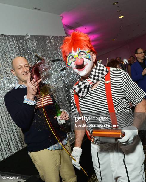 Daniel Sallick, Chair of the Board of Trustees for the Hirshhorn Museum, snaps a photo of one of the clowns featured in the dessert performance of...