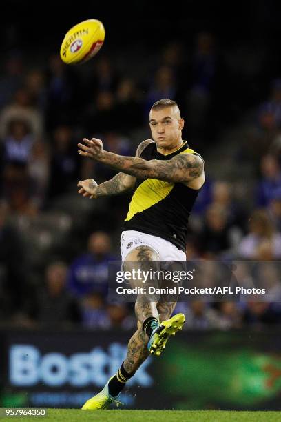 Dustin Martin of the Tigers kicks the ball during the 2018 AFL round eight match between the North Melbourne Kangaroos and the Richmond Tigers at...