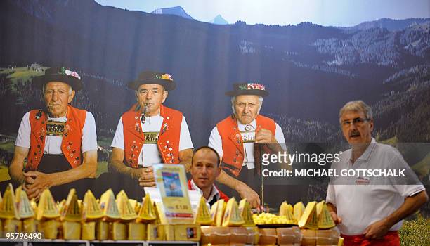 Fair vendors present cheese from Switzerland at their stand at the International Green Week Food and Agriculture fair in Berlin January 15, 2010. The...