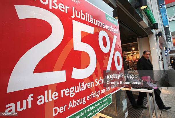 Shopper exits a store advertising sales in Frankfurt, Germany, on Friday, Jan. 15, 2010. Germany's economy shrank more than economists forecast last...