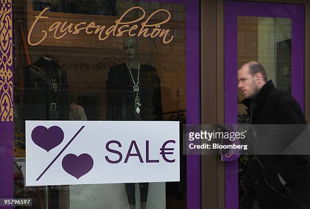 Pedestrian passes a store advertising sales in Frankfurt, Germany, on Thursday, Jan. 14, 2010. Germany's economy shrank more than economists forecast...