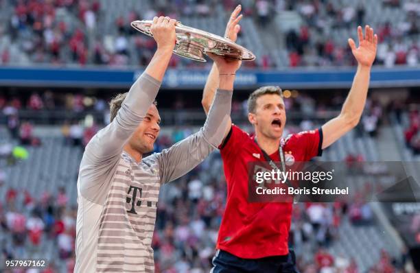 Goalkeeper Manuel Neuer of FC Bayern Muenchen lifts the trophy to celebrate the 28th German football championship after the Bundesliga match between...