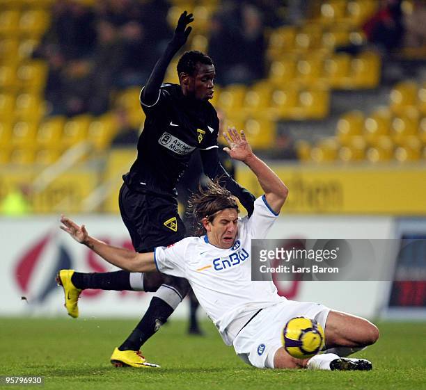 Babacar Gueye of Aachen is challenged by Dino Drpic of Karlsruhe during the Second Bundesliga match between Alemannia Aachen and Karlsruher SC at the...