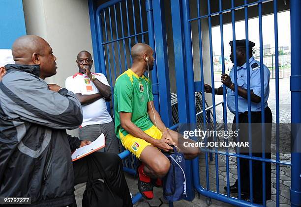 Mali's coach Stephen Keshi and Frederic Kanoute wait in front of locked gates along with other Mali players trying to enter Escoqeiros stadium for...