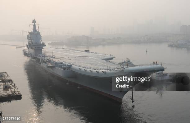 China's first domestically manufactured aircraft carrier, known only as "Type 001A", leaves port in the northeast city of Dalian early on May 13,...