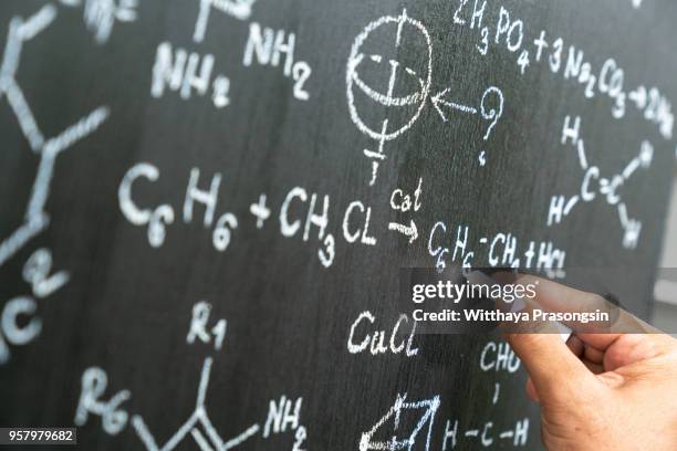 senior chemistry professor writing on the board - physics stock pictures, royalty-free photos & images