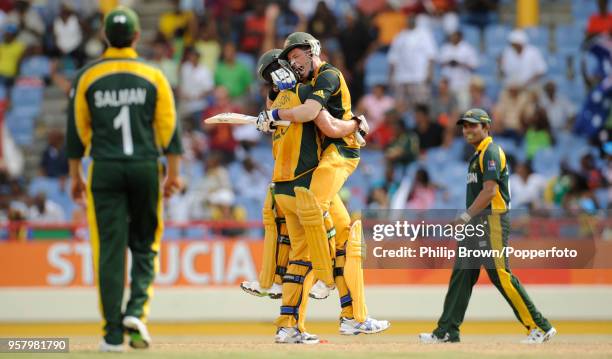 Australia's Michael Hussey celebrates with teammate Mitchell Johnson after Australia win the ICC World Twenty20 Semi Final between Australia and...