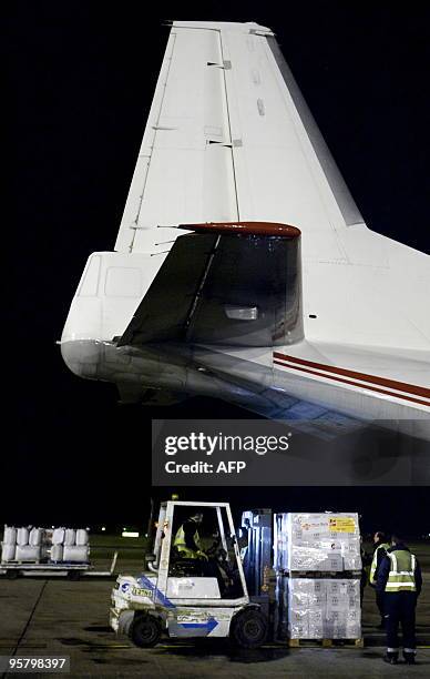 Humanitarian material is loaded on a plane chartered by the Spanish Red Cross ready to take off from Barcelona's airport to Haiti on January 15,...