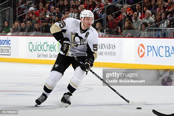 Sergei Gonchar of the Pittsburgh Penguins skates with the puck during the game against the New Jersey Devils at the Prudential Center on December 30,...