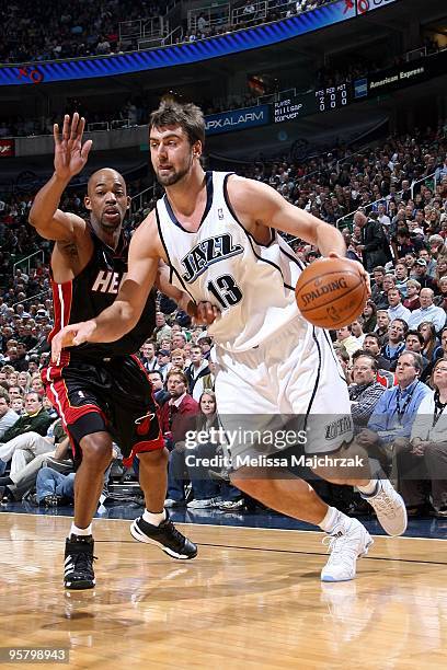 Mehmet Okur of the Utah Jazz drives to the basket against Rafer Alston of the Miami Heat during the game at the EnergySolutions Arena on January 11,...