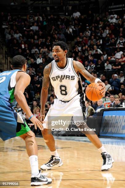 Roger Mason Jr. #8 of the San Antonio Spurs moves the ball against Wayne Ellington of the Minnesota Timberwolves during the game on December 29, 2009...