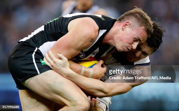 Ben Crocker of the Magpies and Patrick Dangerfield of the Cats compete for the ball during the 2018 AFL round eight match between the Collingwood...