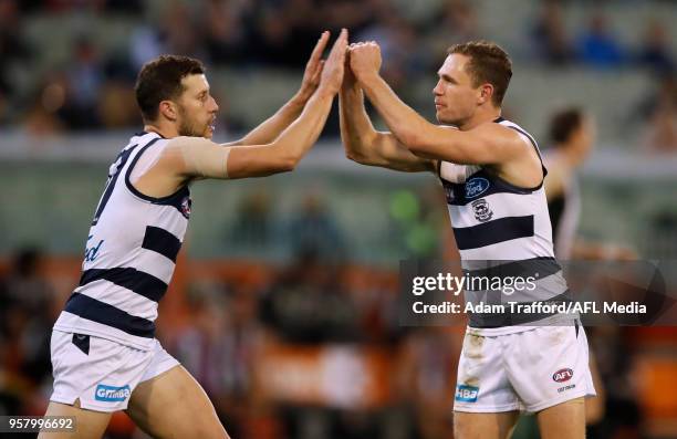 Sam Menegola of the Cats celebrates a goal with Joel Selwood of the Cats during the 2018 AFL round eight match between the Collingwood Magpies and...