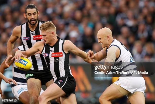 Adam Treloar of the Magpies is tackled by Gary Ablett of the Cats during the 2018 AFL round eight match between the Collingwood Magpies and the...