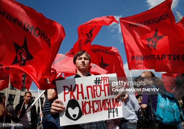 Man holds a poster reading "RKN read the constitution!" during an opposition rally in central Moscow on May 13 to demand internet freedom in Russia.