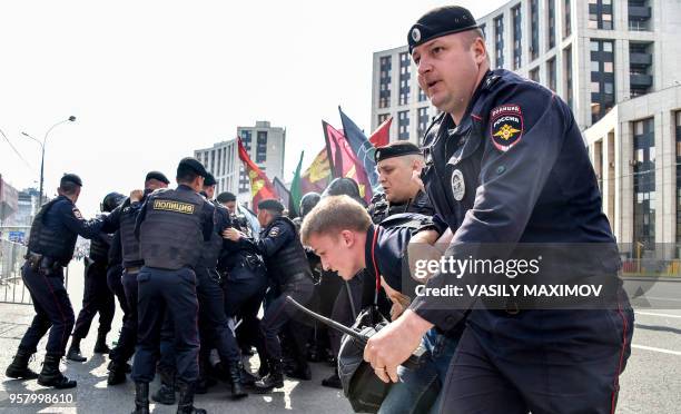 Russian riot police detain an opposition activist during a rally in central Moscow on May 13 to demand internet freedom in Russia. - A Moscow court...