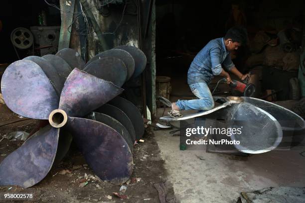 Worker polishes a propeller in a propeler manufacturing workshop in Dhaka, Bangladesh, May 12, 2018.