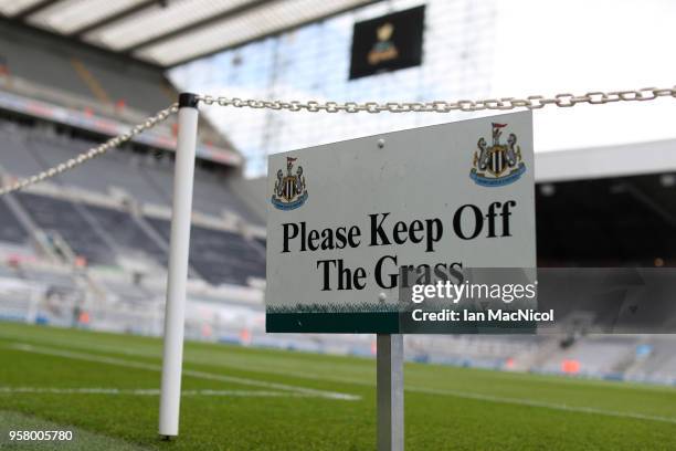 Please keep off the grass sign is seen inside the stadium prior to the Premier League match between Newcastle United and Chelsea at St. James Park on...