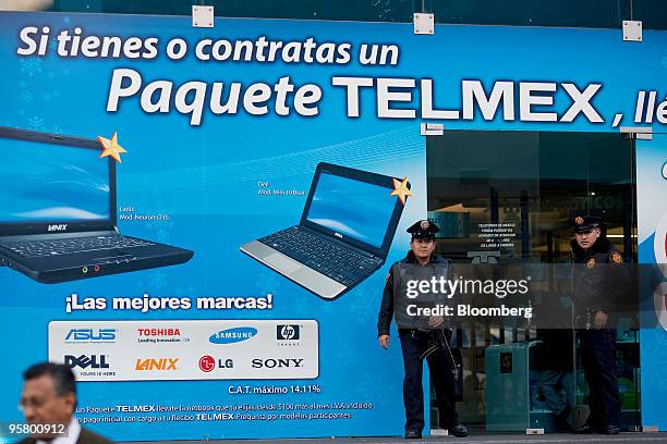 Security officers stand outside the headquarters building of Telmex Internacional SAB in Mexico City, Mexico, on Thursday, Jan. 14, 2010. Carlos...