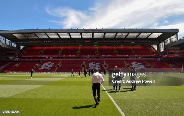 Chris Hughton of manager Brighton and Hove Albion and players look at the pitch before the Premier League match between Liverpool and Brighton and...
