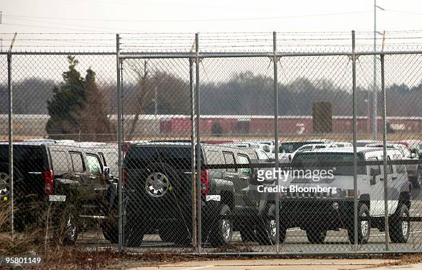 Handful of Hummer H3 vehicles sit inside the fence at the rear entrance of a General Motors Co. Assembly plant in Shreveport, Louisiana, U.S., on...