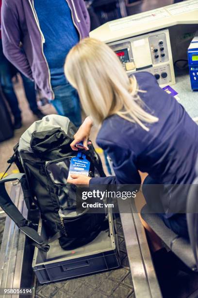 airport employee labeling backpacker's bag - labeling stock pictures, royalty-free photos & images