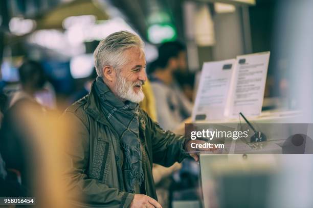 Grey Leader Checking In Mature Greyhaired Man Checking In At Airport Counter High-Res Stock ...