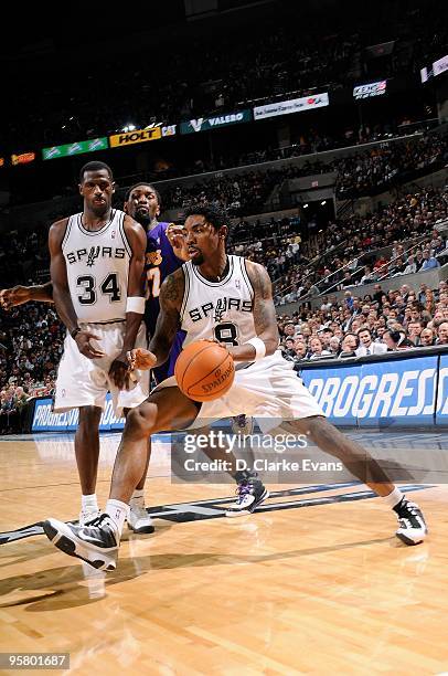 Roger Mason Jr. #8 of the San Antonio Spurs drives the ball around Ron Artest of the Los Angeles Lakers during the game on January 12, 2010 at the...