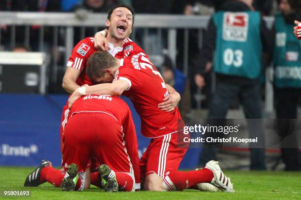 Miroslav Klose celebrates the second goal with Mark van Bommel and Bastian Schweinsteiger during the Bundesliga match between Bayern Muenchen and...