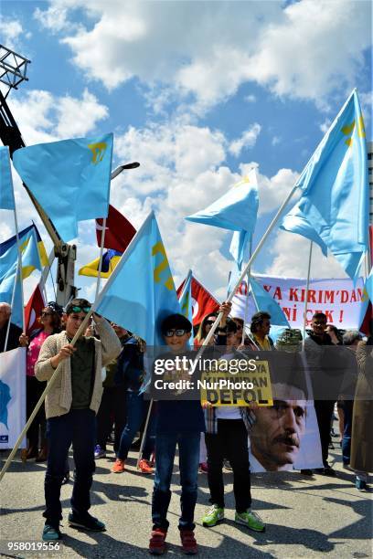 Boys wave flags during a mourning rally marking the Deportation of the Crimean Tatars in Ankara, Turkey, on Sunday, May 13, 2018. A total of 238,500...