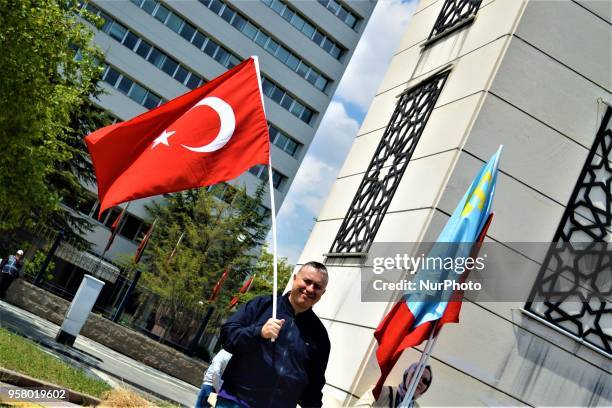 Man waving a Turkish flag poses for a photo during a mourning rally marking the Deportation of the Crimean Tatars in Ankara, Turkey, on Sunday, May...