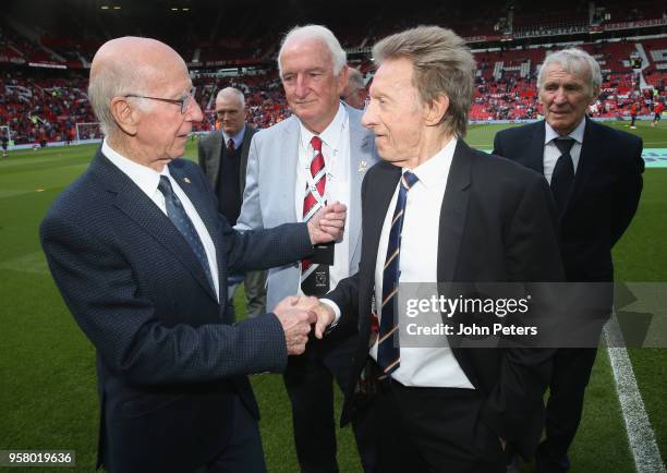 Sir Bobby Charlton and Denis Law meet ahead of the Premier League match between Manchester United and Watford at Old Trafford on May 13, 2018 in...