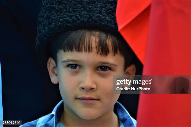 Boy wearing a traditional hat looks on during a mourning rally marking the Deportation of the Crimean Tatars in Ankara, Turkey, on Sunday, May 13,...