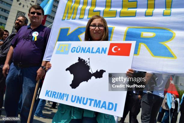Girl holds a placard during a mourning rally marking the Deportation of the Crimean Tatars in Ankara, Turkey, on Sunday, May 13, 2018. A total of...