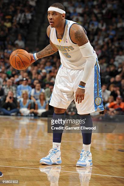 Carmelo Anthony of the Denver Nuggets moves the ball against the Dallas Mavericks during the game on December 27, 2009 at the Pepsi Center in Denver,...