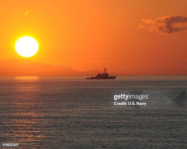 The guided-missile destroyer USS Higgins is underway January 15, 2010 off the coast of Haiti. The Carl Vinson and Carrier Air Wing 17 are conducting...