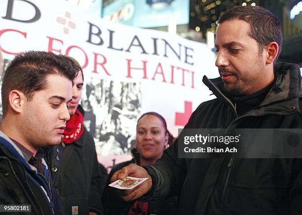 Magician David Blaine performs to help raise money for Haitian earthquake victims on Military Island, Times Square on January 15, 2010 in New York...